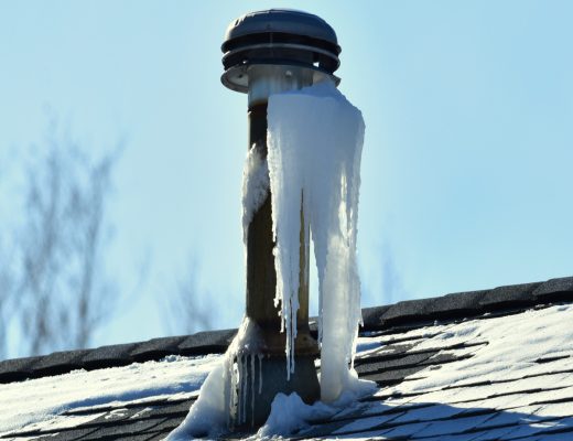Icicles collect around a roof vent where moist exhaust air from the home meets the cold outside air.