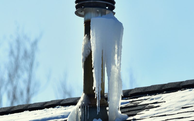 Icicles collect around a roof vent where moist exhaust air from the home meets the cold outside air.