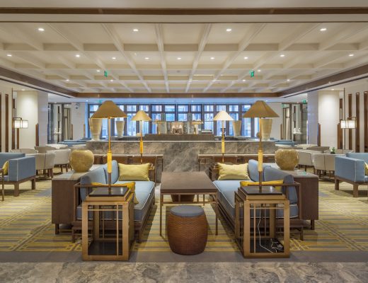 A luxurious, well-decorated lobby with ambient lighting, ample seating, and a cohesive overall design.