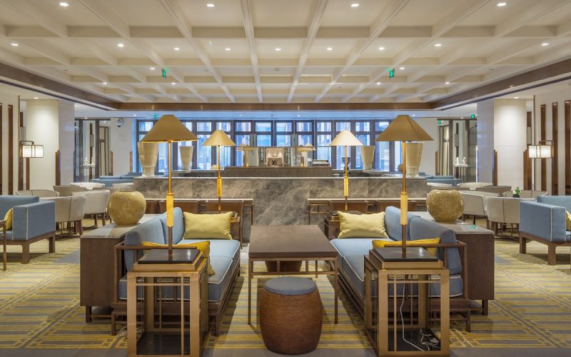 A luxurious, well-decorated lobby with ambient lighting, ample seating, and a cohesive overall design.