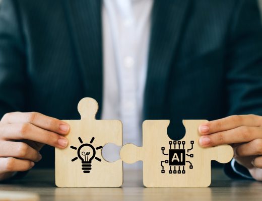 A man wearing a suit, sitting at a desk and holding a puzzle piece with a light bulb on it and another piece with "AI" on it.